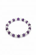Beaded bracelet with purple and clear beads on a light background
