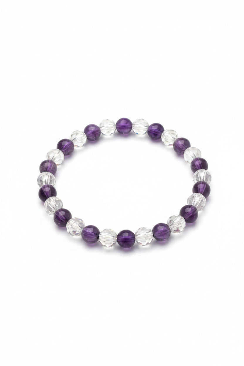 Beaded bracelet with purple and clear beads on a light background
