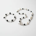 Bracelet with black beads, white pearl beads and clear beads