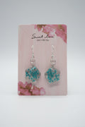 Pair of earrings on a 'Sweet Love' branded card with floral design.