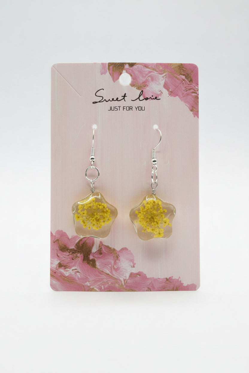 Yellow flower-shaped earrings on a 'sweet love' branded card with floral design.