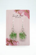 Green floral earrings on a 'sweet love' card with floral design