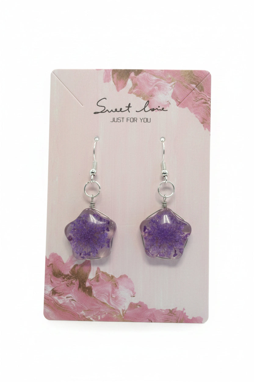 Purple and gold earrings on a floral card with 'sweet love' text