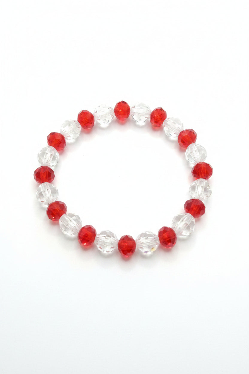 Bracelet with red and clear beads on a wooden surface