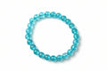 Blue beaded bracelet on a textured gray surface