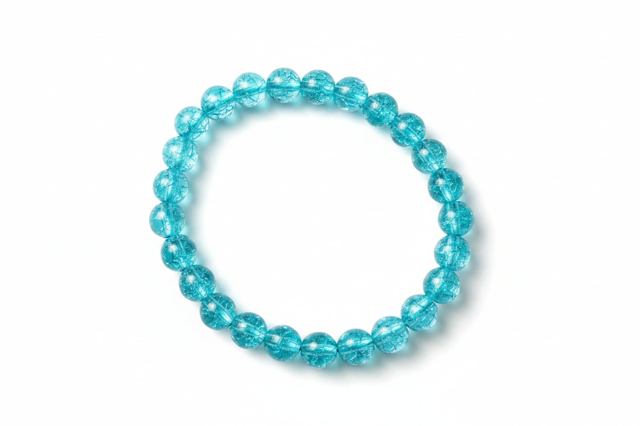 Blue beaded bracelet on a textured gray surface