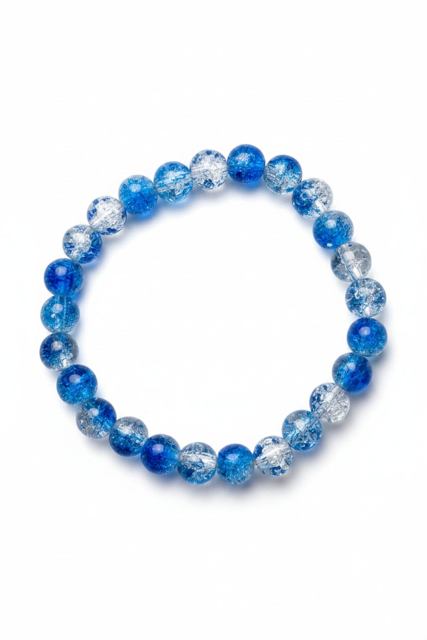 Blue and clear beaded bracelet on a textured surface