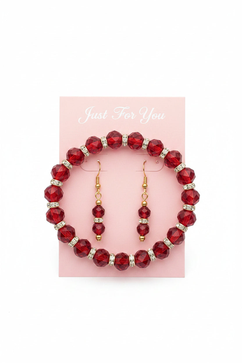 Red beaded bracelet with gold accents on a purple fabric background