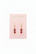 Red beaded necklace and earrings set on a pink card with 'Jewel to Me' branding.