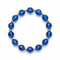 Blue beaded bracelet on a purple fabric background