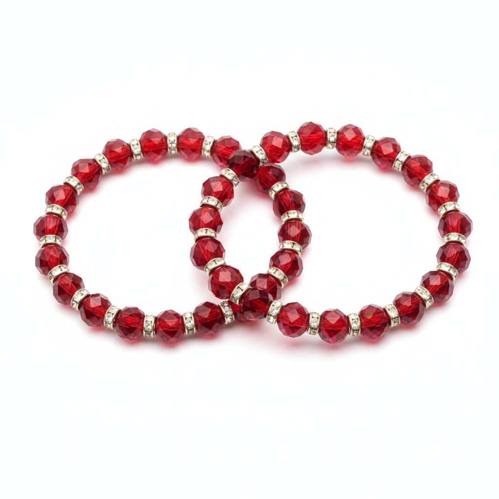 Red beaded bracelet with gold accents on a purple fabric background