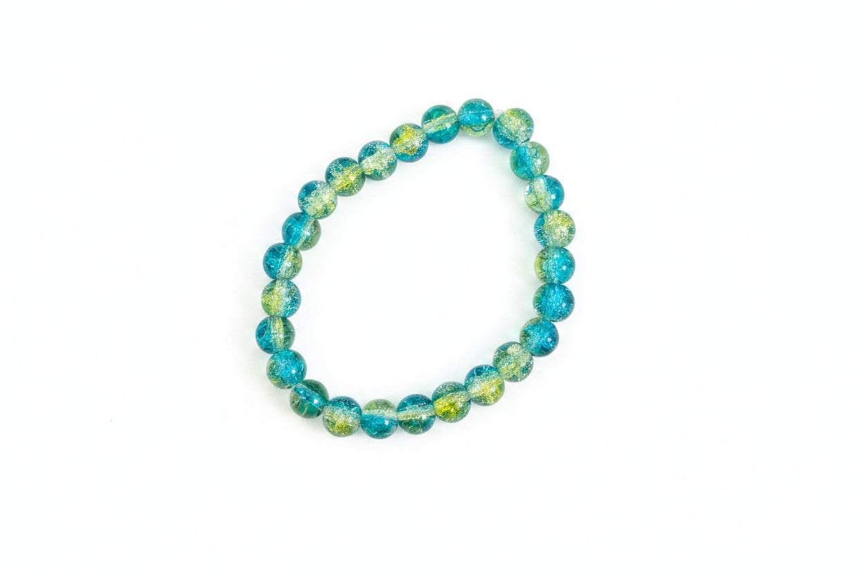 Beaded bracelet with blue and green beads on a marble surface