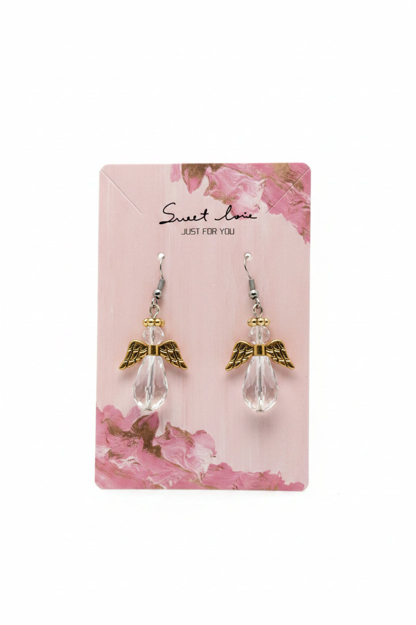 Angel wing earrings on a 'Sweet Love' branded card against a purple fabric background